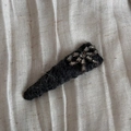 Detailed view of grey felt hair clip with sparkling rhinestone bow on textured fabric - Dark Grey Bowtie