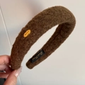 Detailed macro view of the coffee brown plush headband with gold Love metal plate - Dark Coffee