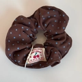 Close-up of brown polka dot scrunchie with a woven Sweet Cherry textile label - Coffee Polka Dot Scrunchie