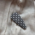 Detailed view of gray fabric polka dot BB hair clip on a minimalist textured background - Polka Dot Water Drop Clip / Gray