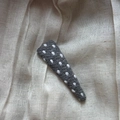 Close-up of handmade dark grey woven BB hair clip with white polka dot embroidery details - Polka Dot Triangle Clip / Gray