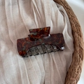 Close-up of a tortoiseshell acetate hair claw clip with golden Barrette la France text - Blue Coffee