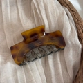 Detailed view of the tortoiseshell hair claw clip with Barrette La France gold engraving - Dark Tortoiseshell