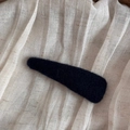 Detailed view of the black fuzzy texture on the teardrop-shaped felt hair clip - Blue Triangle Style