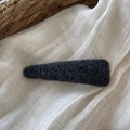 Detailed texture of dark grey felt BB hair clip on a soft natural linen background - Triangle Style / Black and Gray