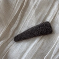 Close-up of a dark brown wool felt BB hair clip showing soft fiber texture on fabric - Triangle Style / Dark Khaki