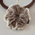 Detail of a large knit scrunchie with mixed brown wool and white fringe edges - Fuzzy Edge Snowflake Knit Coffee Scrunchie