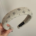 Detail of wide grey felt headband with snowflake prints and a handmade woven label - Headband / Beige Style