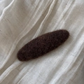 Detailed view of dark brown felt fabric hair clip on a natural linen background - Oval / Dark Brown
