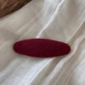 Macro detail of the dark red felt fabric texture on a minimalist oval BB hair clip - Oval / Red