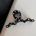 Close-up of a glossy black and white polka dot hair claw clip with a wavy wave structure - Black Polka Dot Wavy Straight Style