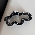 Detailed view of the wavy black hair claw clip featuring classic white polka dots - Black Polka Dot Cloud Style