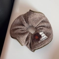 Close-up of brown knit scrunchie with crochet flower and dreamer fabric label detail - Coffee Knitted Flower Scrunchie