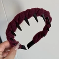 Detailed close-up of dark red braided knit headband with non-slip interior teeth - Burgundy