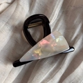 Close-up of a pearlescent acetate triangle hair claw with gold logo on fabric - Triangle Acetate Patch (Mermaid White) / Mermaid White