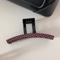Close-up of a burgundy hair claw clip with white polka dots on a minimalist cream surface - Red (Large Claw)