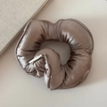 Detail view of a large oversized satin hair scrunchie in elegant taupe with branding label - Champagne