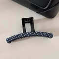 Detail of a minimalist navy blue polka dot hair claw clip with a secure grip mechanism - Navy Blue (Large Claw)