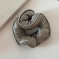 Macro shot of large sage green silk satin scrunchie with a soft glossy texture and thick padding - Green