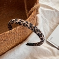 Detailed view of handmade fabric leopard print scrunchie with high elasticity and label - Narrow Leopard Print Headband
