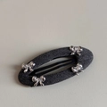 Detail of grey herringbone fabric oval hair clip with four silver metal bows - Oval Cutout BB - Silver Bow