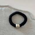 Detail of black pleated fabric hair scrunchie with a polished silver metallic bead accessory - Black