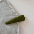 Detail of an olive green knit wool hair clip on a minimalist beige linen surface - Solid Color Woolen Triangle BB Clip / Green