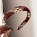 Detail showing the red tartan fabric texture and handmade label of the padded headband - Padded Plaid Headband - Red