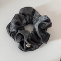 Detail of grey paisley scrunchie featuring a white BOTANI button and soft fabric texture - Grey Cinched Style