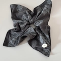 Detail of dark grey paisley fabric scrunchie with BOTANI label and vintage floral patterns - Grey Square Style