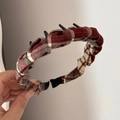 Detail of a brown plaid headband with integrated black hair clips for styling and braiding - Toothed Plaid Headband - Red