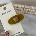 Detail of a mustard yellow velvet oval hair clip featuring a cute 3D flocked brown bear - Yellow