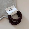 Detailed macro view of two luxury satin hair scrunchies with smooth texture and soft folds - Dark Coffee