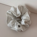 Detail of white striped scrunchie featuring a vintage grey heart-shaped metal charm - Striped Tie Scrunchie - White