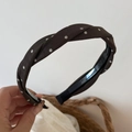 Detail van de bruine polkadot hoofdband met antislip binnenzijde en gedraaid ontwerp - Gevlochten Stippen Stijl / Bruin