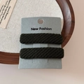 Detail of dark green twill fabric sponge hair clips showing textured knit pattern - Green