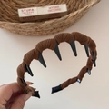 Detail view of the brown corduroy fabric texture and non-slip inner teeth on the headband - Brown