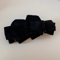 Close-up of elegant multi-layered black suede bow banana hair clip for women ponytail - Black