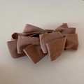 Detailed view of large multi-layer mocha suede bow hair clip with elegant fabric texture - Camel