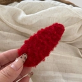 Close-up of red plush lamb wool BB hair clip showing fluffy texture and secure metal clasp - Red