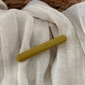 Close-up of minimalist olive green acetate hair claw clip on soft textured linen fabric - Yellow Green - Duckbill Clip