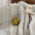 Detail view of yellow flower hair claw clip with crystal center on a white fabric base - Yellow Green - Flower Mini Claw