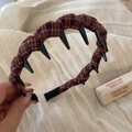 Detail view of reddish brown checkered fabric headband with inner grip teeth for stability - Long Teeth Style - Red Plaid