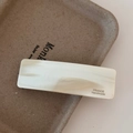 Close-up of marble-textured cream acetate rectangular hair clip with gold engraving - Cream White Marble