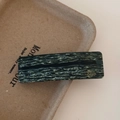 Detail view of large marble green acetate hair clip with gold France Handmade logo - Dark Green Marble