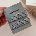 Detail of grey and black diagonal knit hair clips on display card for women - Grey/White