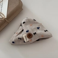 Detail view of handmade cotton linen fabric hair clip with embroidery and button detail - White Claw Clip