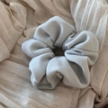 Close-up of a large light blue velvet scrunchie with soft pleated texture and elastic band - Flannel Solid Scrunchie - Light Blue