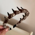 Detail of brown plaid fabric headband showing wave teeth and non-slip texture - Toothed Plaid Headband - Coffee