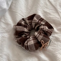 Detail of a brown plaid flannel hair scrunchie with button and happiness label decoration - Plaid Scrunchie - Coffee